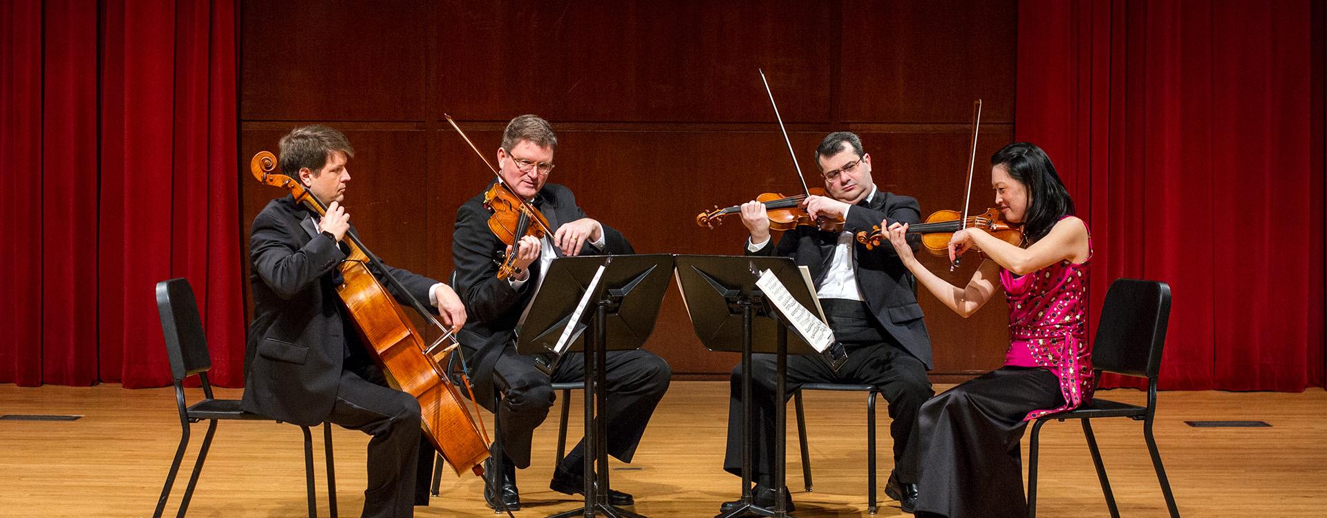 Philomusica Quartet on Schwan Concert Hall stage with instruments